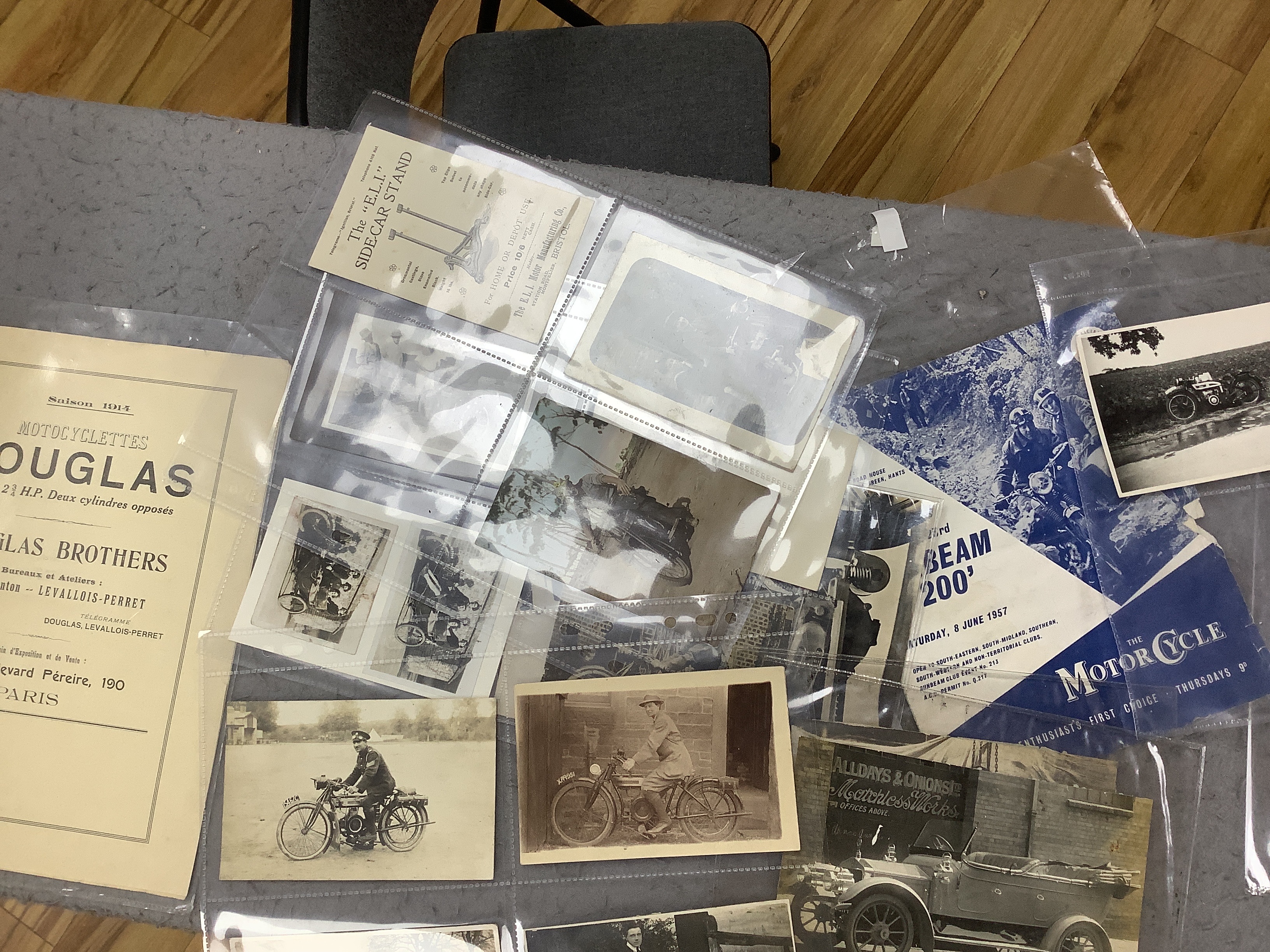 A collection of early motorcycle ephemera, postcards and black and white photographs